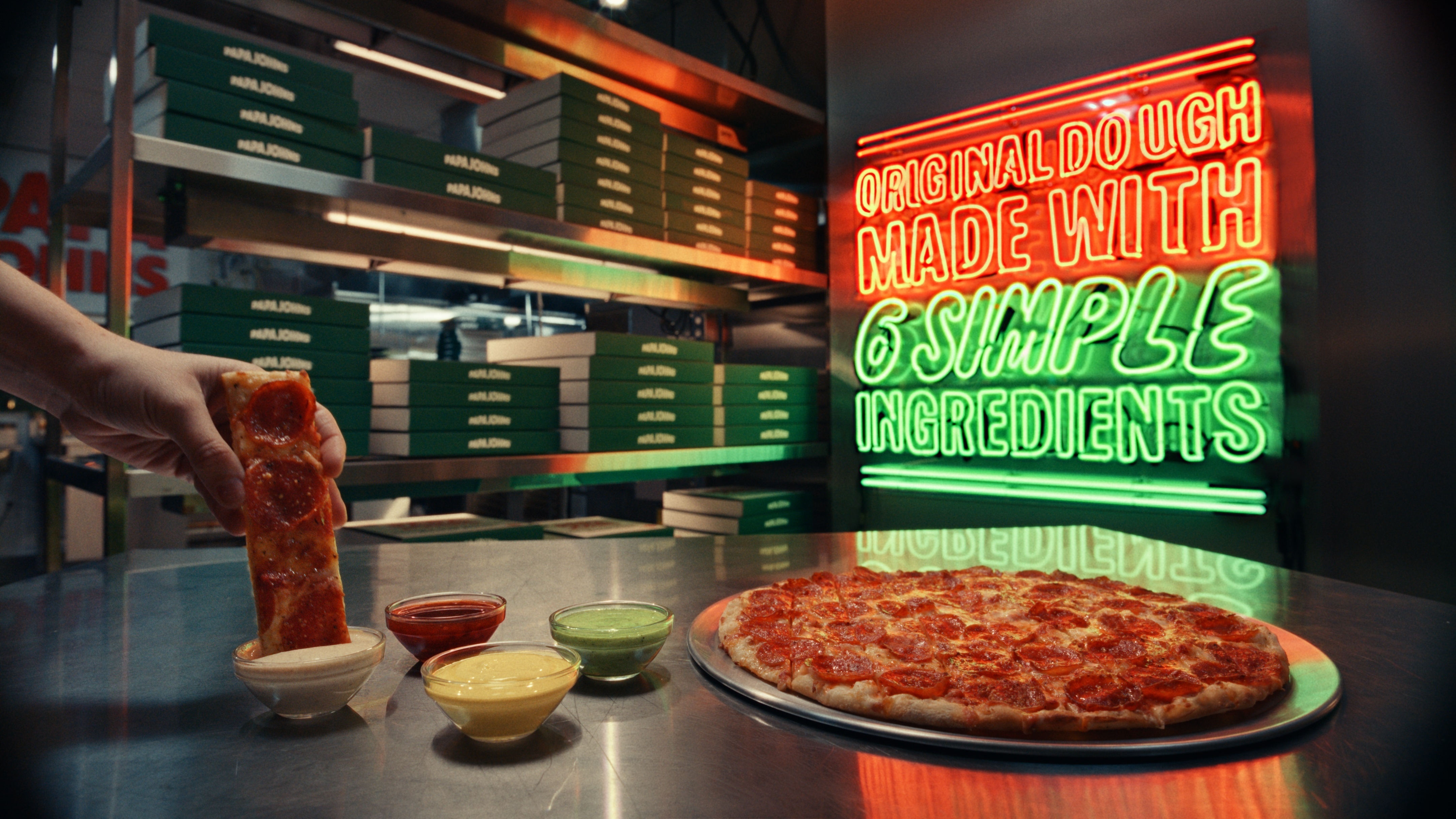 Pizza being dipped into garlic dip