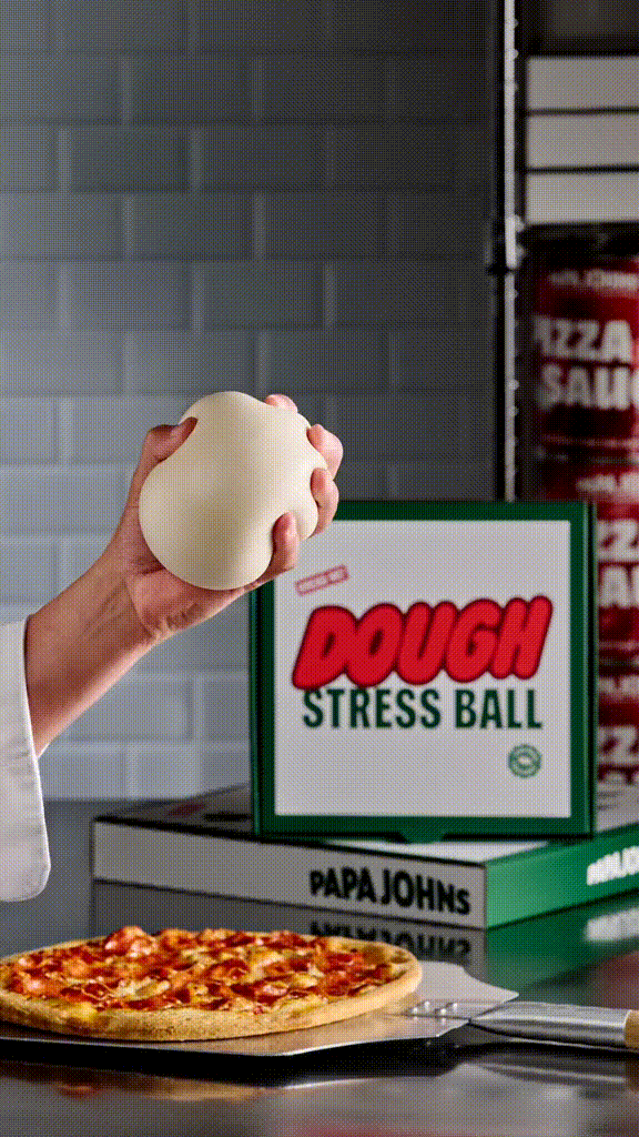 A hand squishing a dough stress ball
