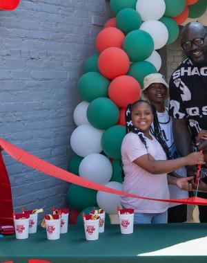 Shaq and local youths cut the ribbon at new Papa Johns restaurant