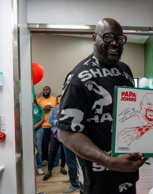 Shaq signing pizza boxes at Papa Johns