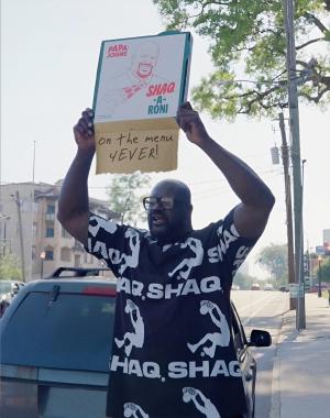 Shaquille O'Neal holding a Shaq-a-Roni box