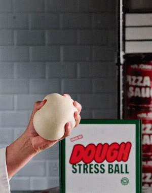 A hand squishing a dough stress ball