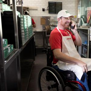 Papa Johns team member assisting customers via phone