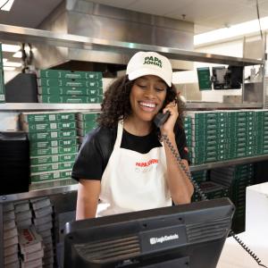 Papa Johns team member assisting customers via phone