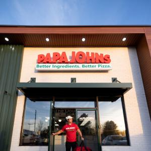 Driver exiting Papa Johns restaurant 