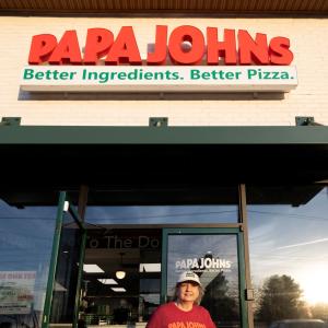 Driver exiting Papa Johns restaurant
