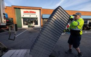 A man unloading trays outside a Papa Johns restaurant