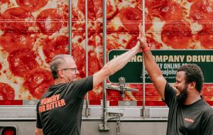 Two Papa Johns team members giving a high-five