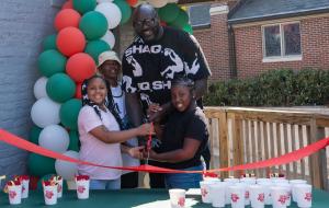 Shaq and local youths cut the ribbon at new Papa Johns restaurant