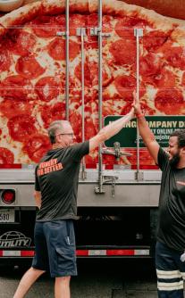 Two Papa Johns team members giving a high-five