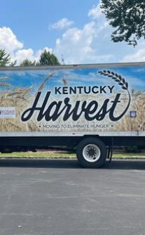 A truck with a sign that reads "Kentucky Harvest" 