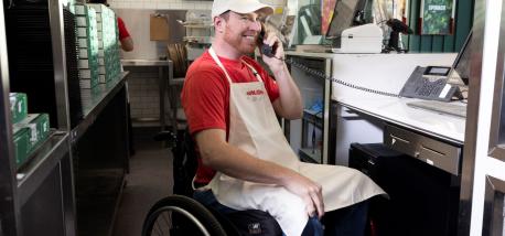 Papa Johns team member assisting customer on phone