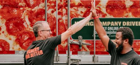 Two Papa Johns team members giving a high-five