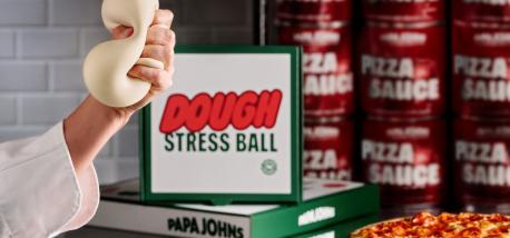 A hand squishing a dough stress ball