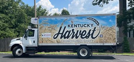 A truck with a sign that reads "Kentucky Harvest" 