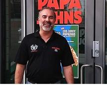 Andy Freitas standing outside one of his Papa Johns restaurants.