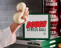 A hand squishing a dough stress ball